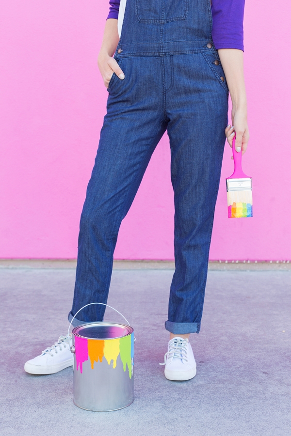 A close up of someones jeans and a rainbow paint brush