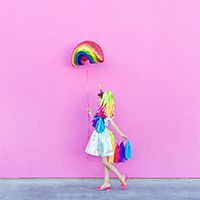 DIY Lisa Frank Costumes A woman dressed in a unicorn costume