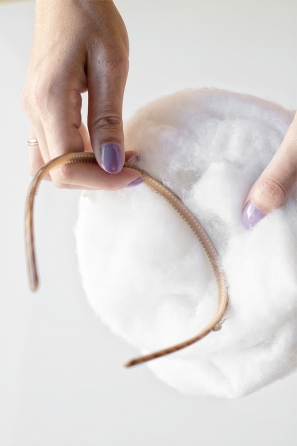 Someone holding cotton and a hairband