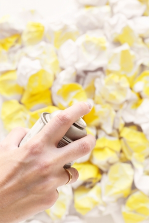 Someone spraying painting something yellow