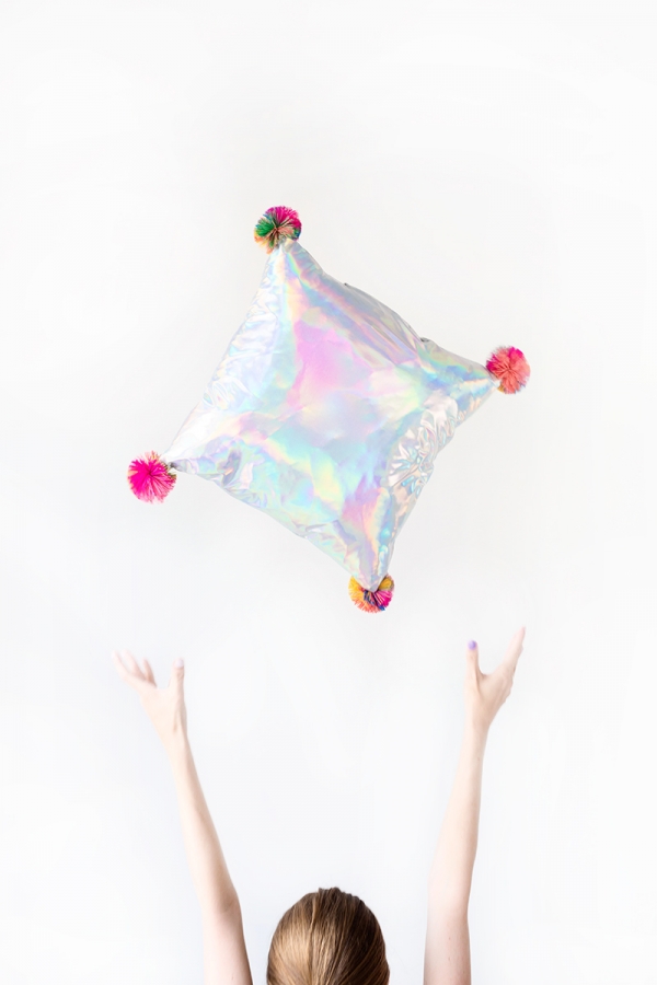 Someone throwing a pillow in the air