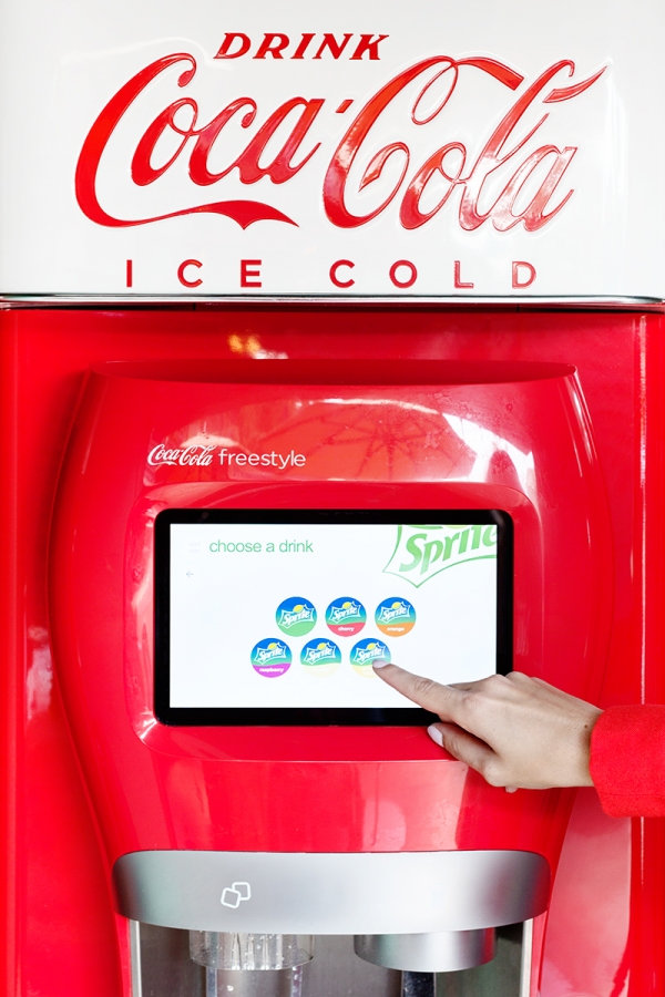 Someone selecting a drink on a drink machine