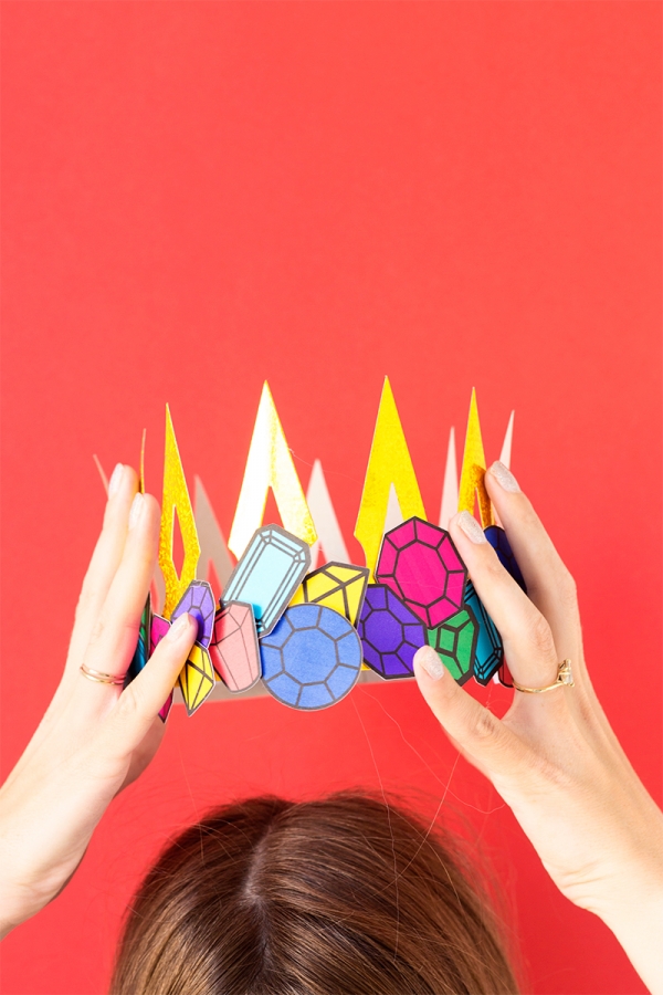 Someone holding a paper crown 
