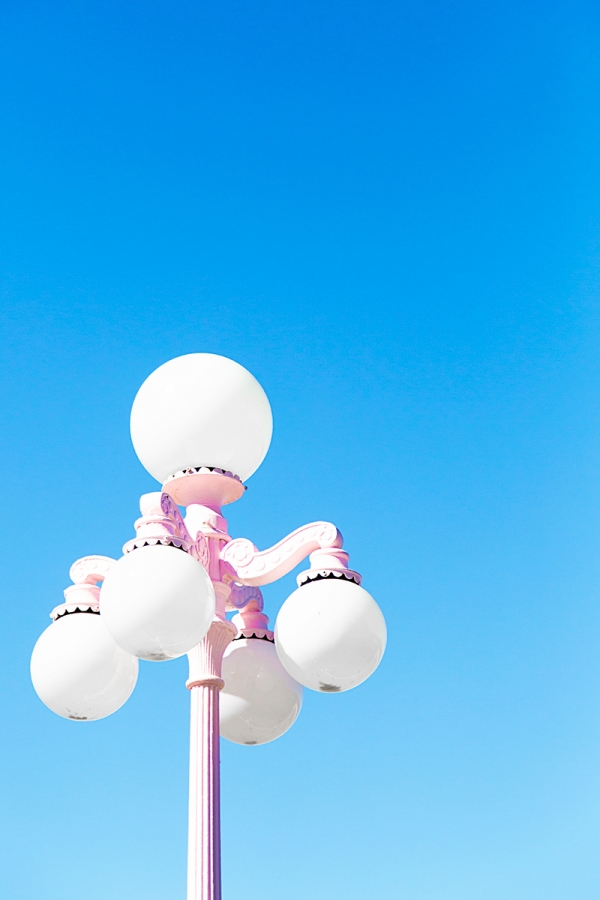 A close up of a pink street lamp