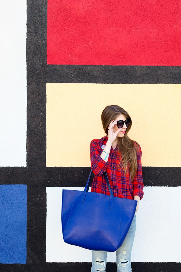 A woman standing in front of a colorful wall
