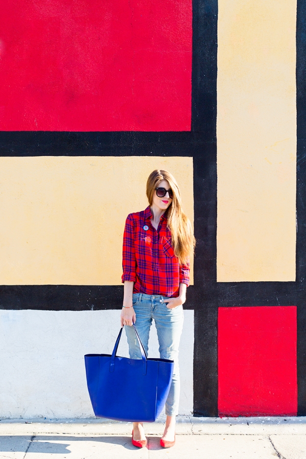 A woman standing in front of a colorful wall