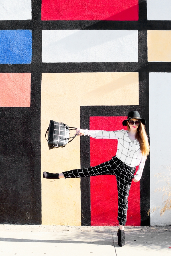 A woman standing in front of a colorful wall