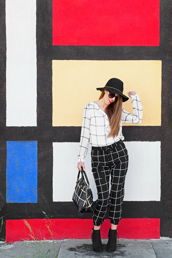 A woman standing in front of a colorful wall