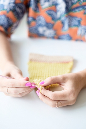Someone sewing something yellow