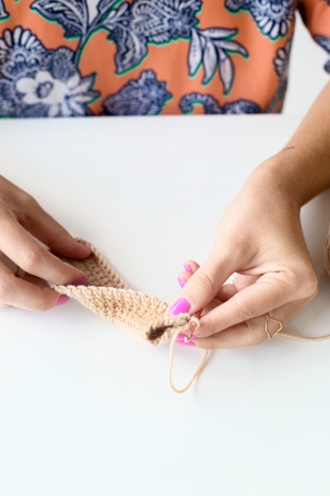 Someone sewing something beige 