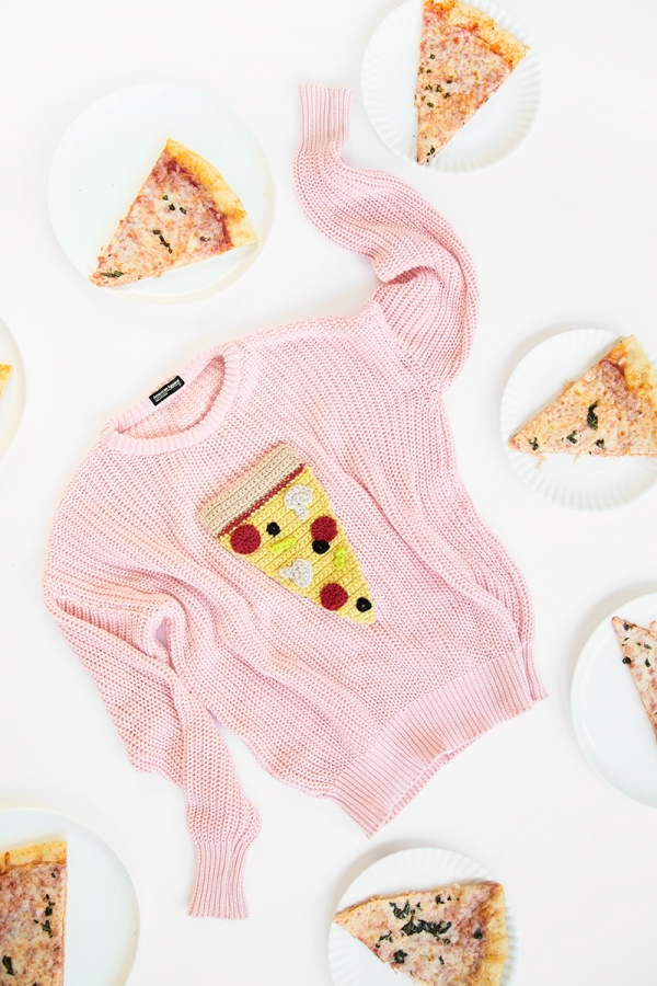 A pizza sweater and pizza