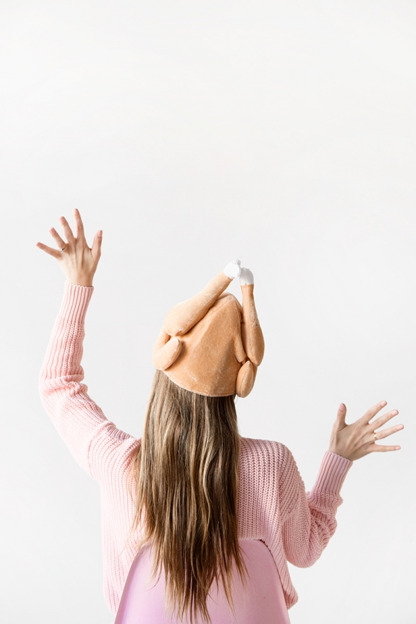 A woman wearing a chicken hat