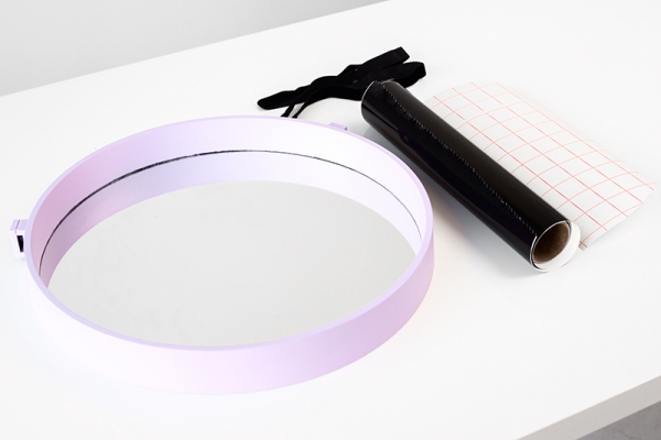A mirror with a purple rim