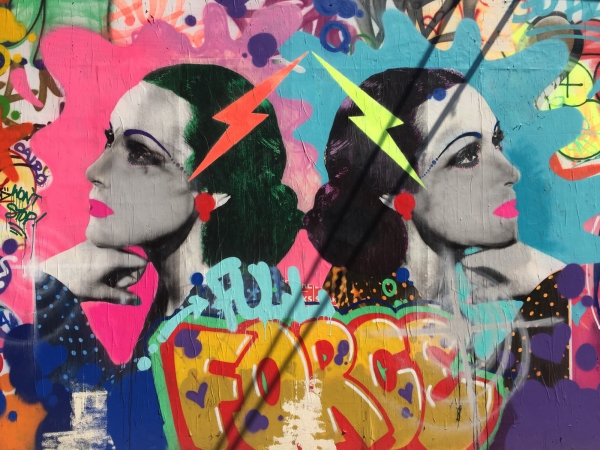 Colorful mural with words and faces