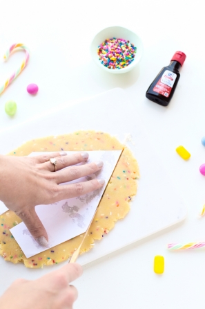 Someone putting paper on dough