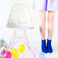 The Studio DIY x Modernica Confetti Chair! (+ A Giveaway!) A chair with colorful dots and a person standing next to it