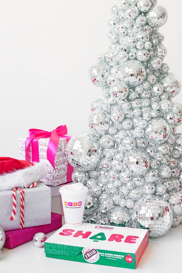 A disco ball Christmas tree and pink presents