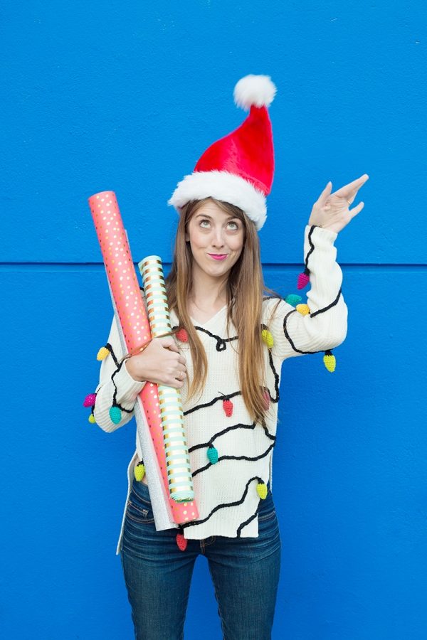 A woman wearing a christmas light sweater