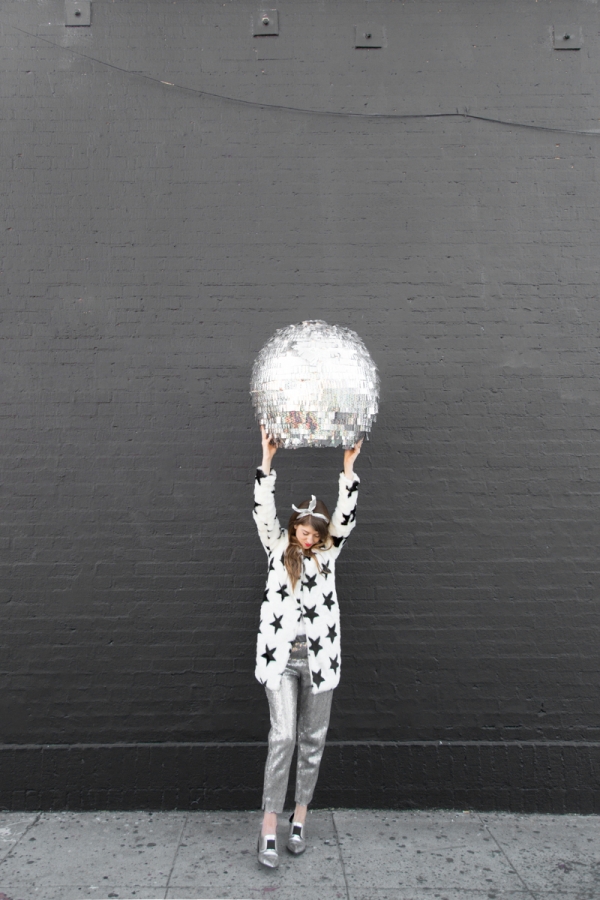 A woman holding a disco ball