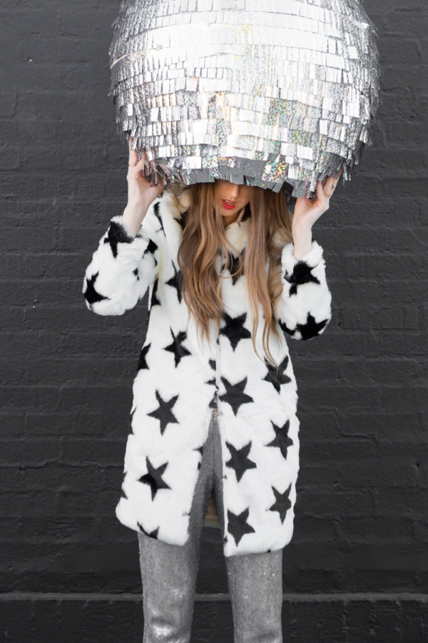 A woman holding a discoball
