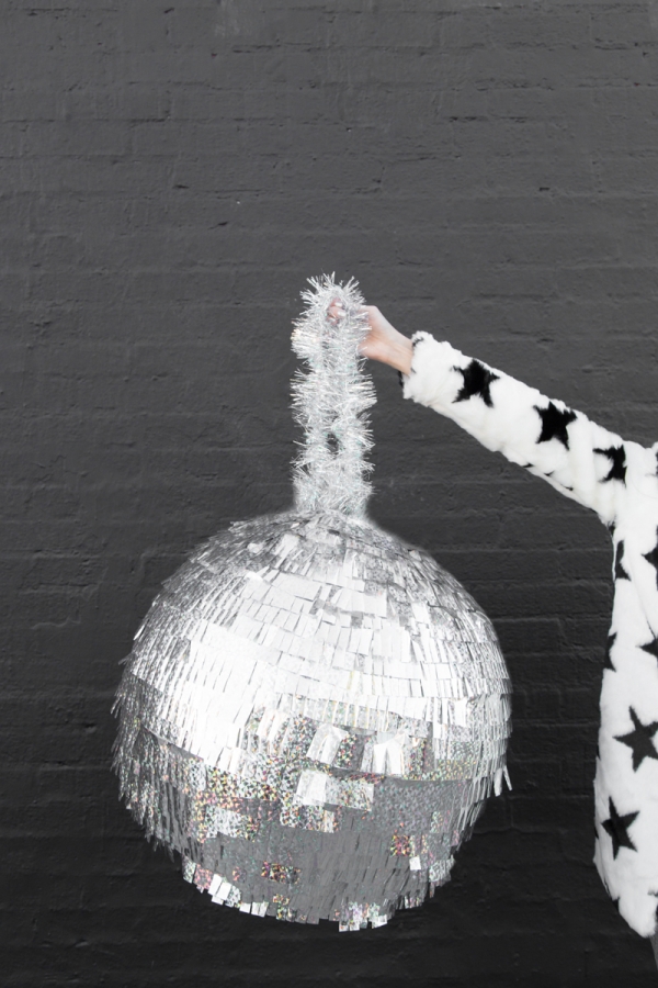 A woman holding a disco ball