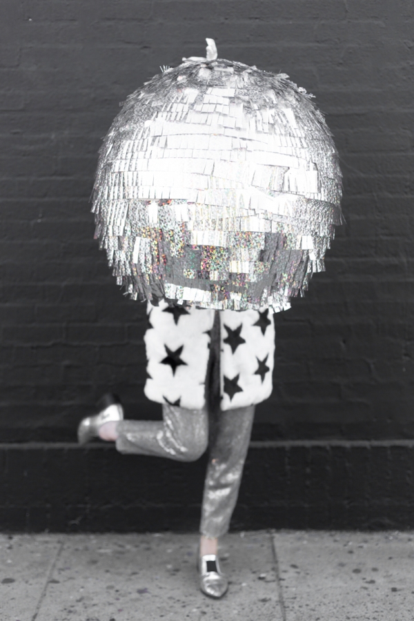 A woman holding a disco ball