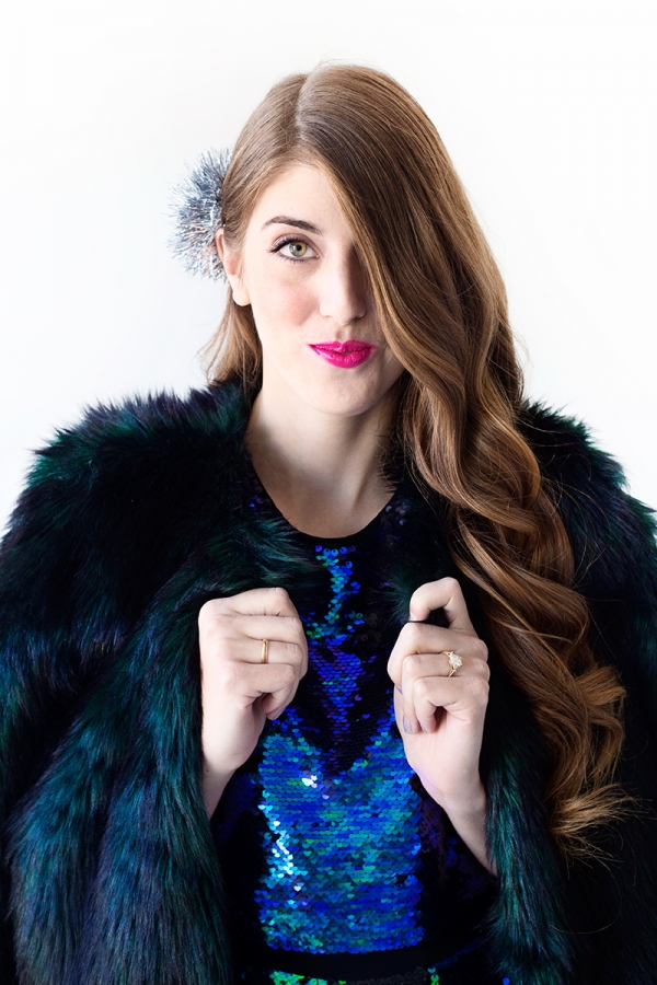 A woman wearing a black fur jacket