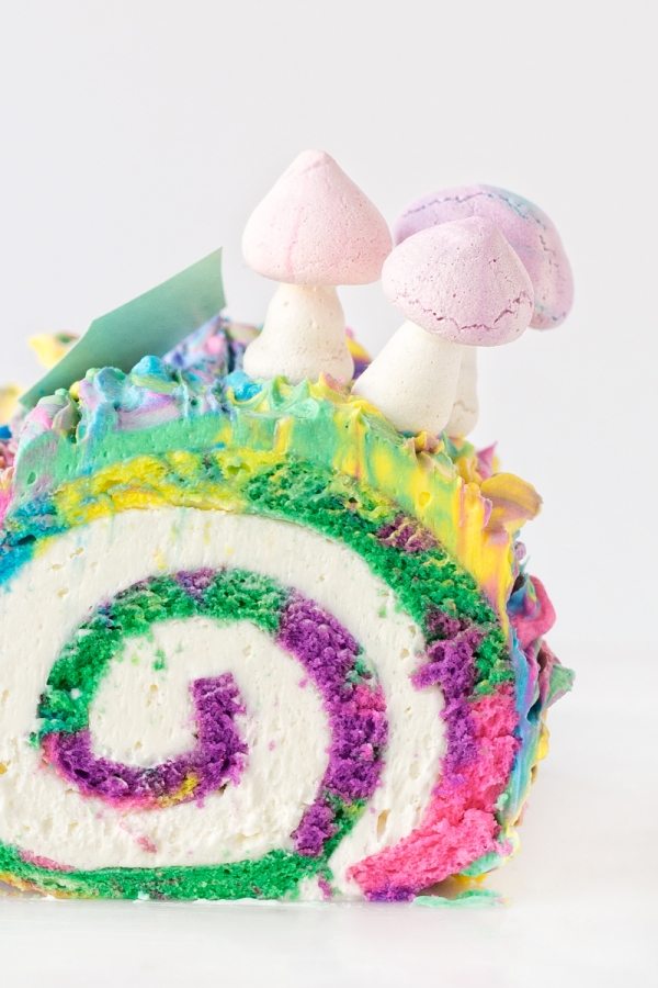 Rainbow yule log dessert with mushrooms