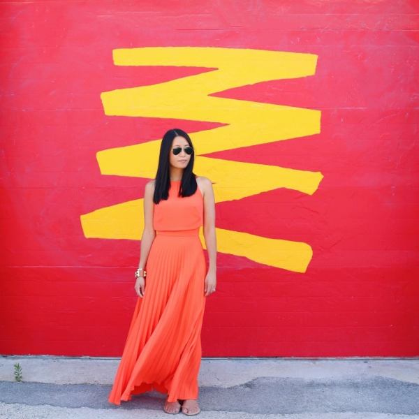 A woman standing in front of a red wall