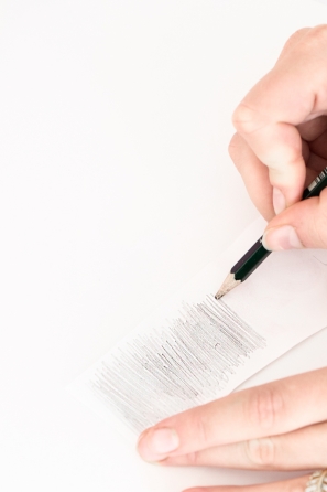 Someone writing something on a paper