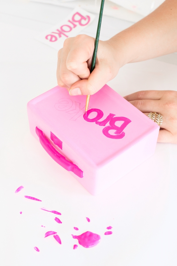 Someone painting a box