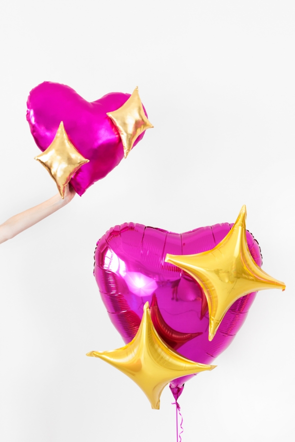 A pink balloon and pillow