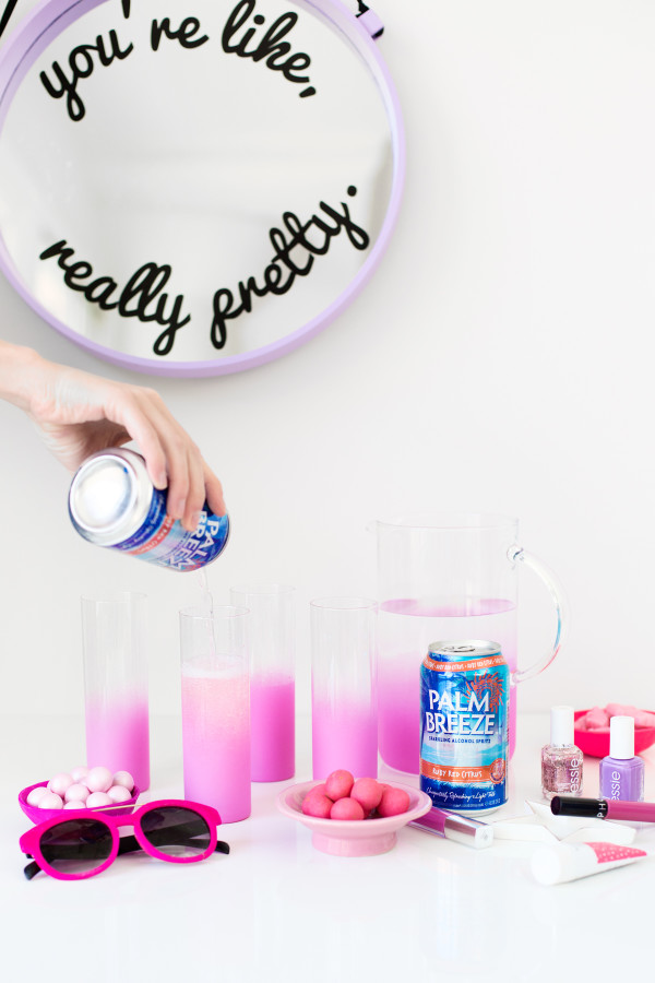Someone pouring a drink into glasses