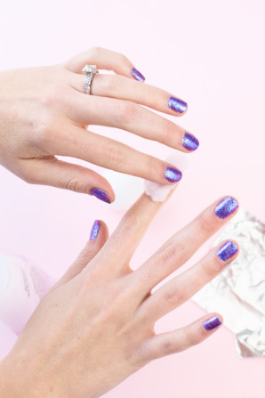 Someone with purple nails