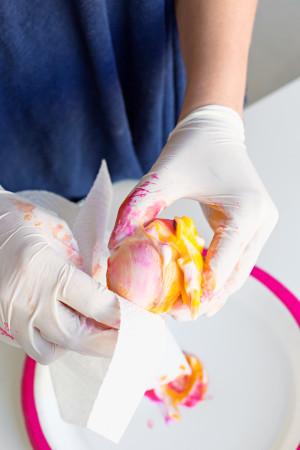 Someone holding a colorful egg