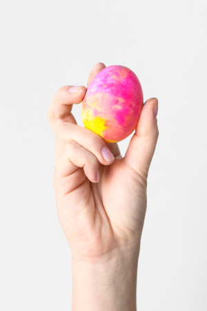 Someone holding a colorful egg