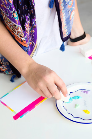 Someone painting a card