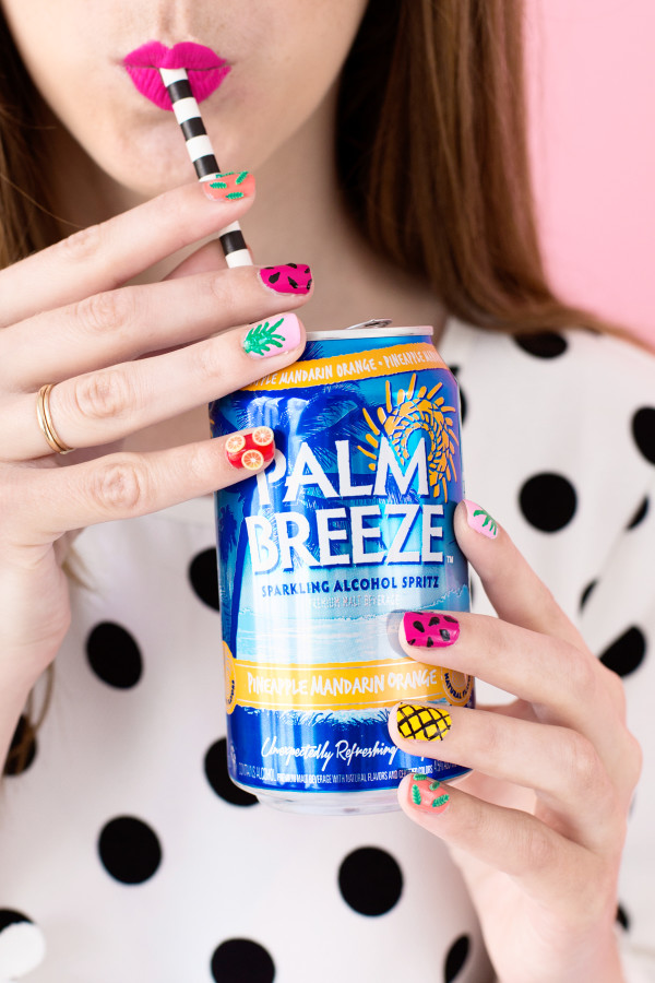 Someone holding a palm breeze drink