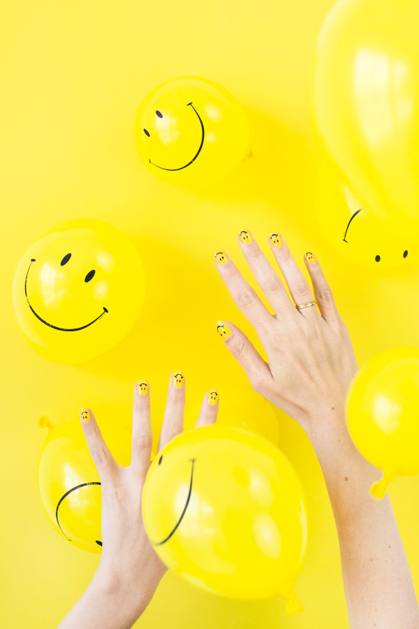 Hands and yellow balloons