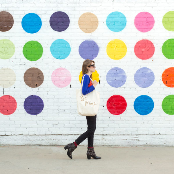 A woman standing in front of a polka-dot wall