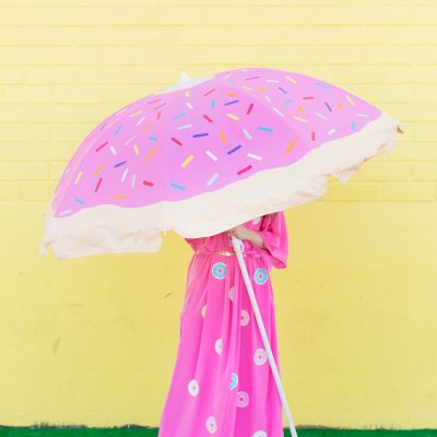 DIY Donut Beach Umbrella Someone wearing a pink dress and holding a pink umbrella