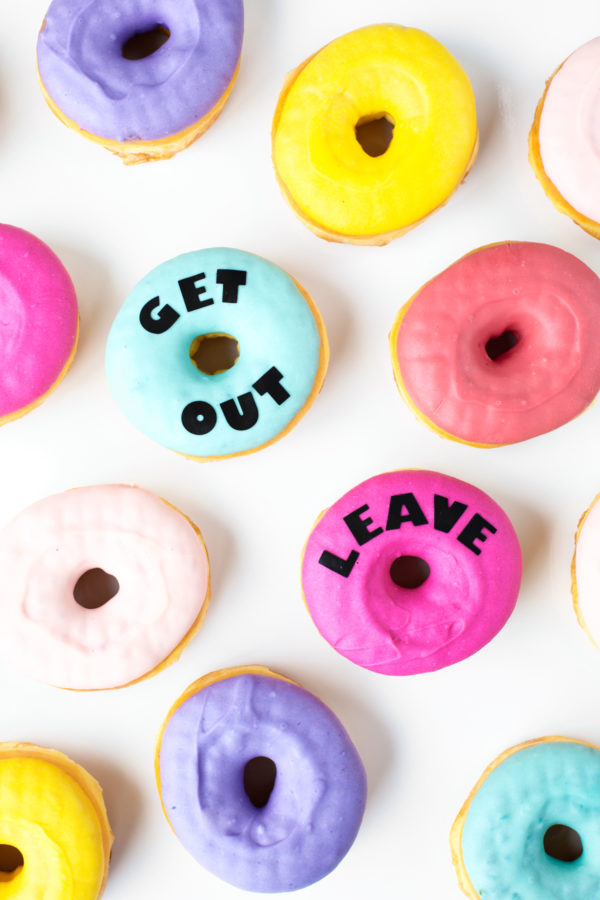 Donuts that say \"get out\" and \"leave\"