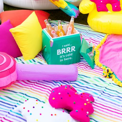 How To Throw A Colorful Backyard Movie Night! Cooler and pillows