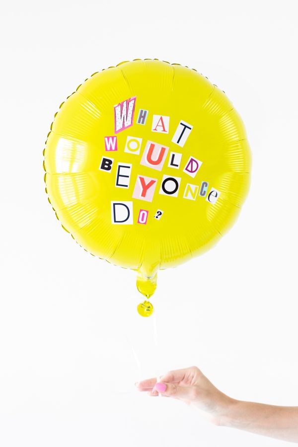 A yellow ballon that says, \"what would Beyonce do?\"
