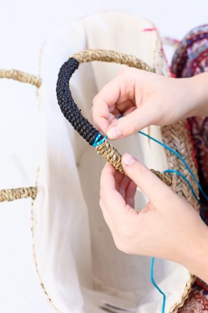 Someone gluing string to a bag