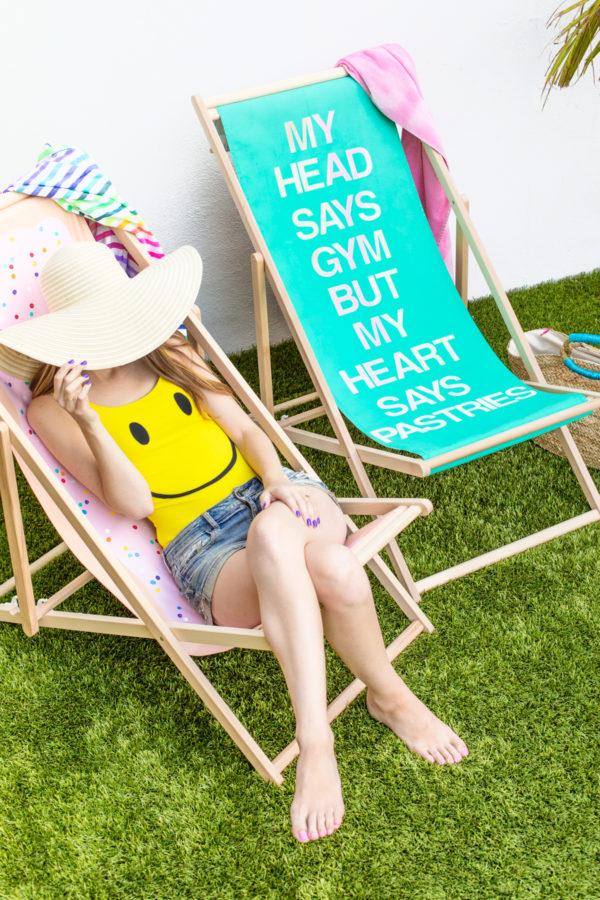 A woman sitting on a pop tart beach chair