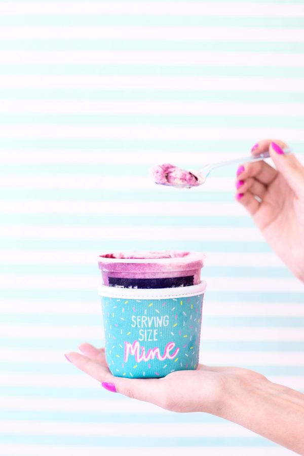 Someone holding a tub of ice cream