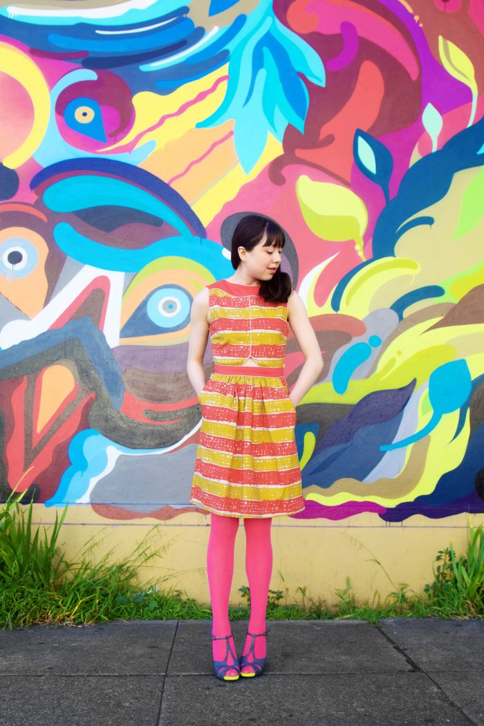Someone standing in front of a colorful wall