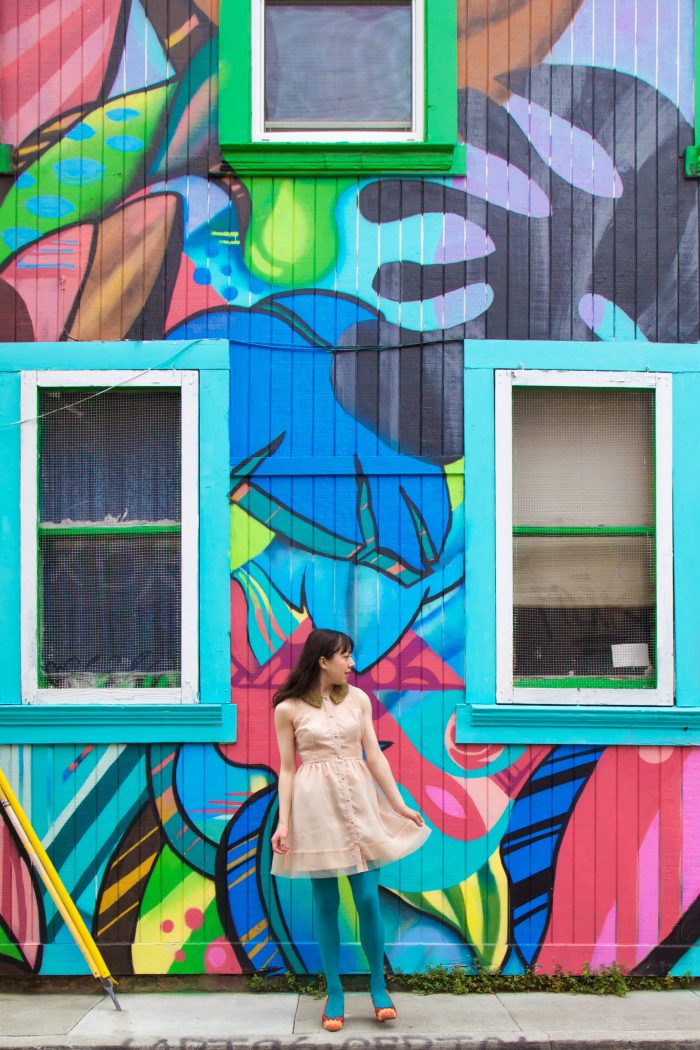 Someone standing in front of a colorful wall