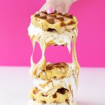 Someone holding waffle sandwiches